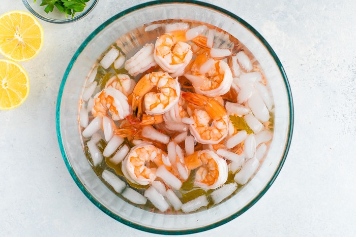 Bowl with cooked shrimp in an ice bath to stop cooking.