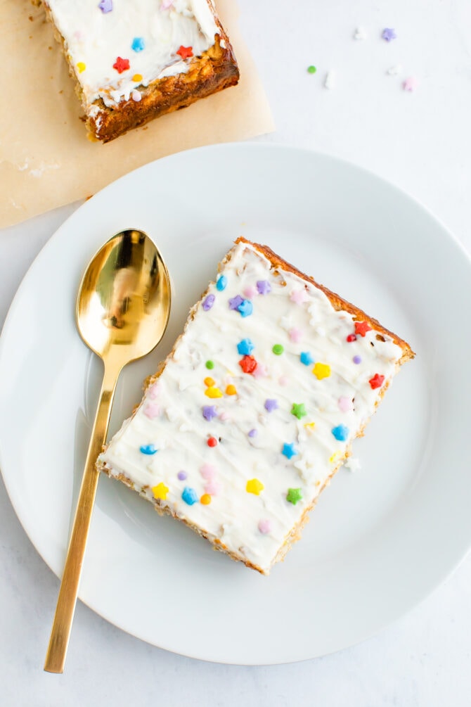 Plate with a slice of birthday cake baked oatmeal and a spoon.