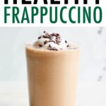 Homemade frappuccino topped with whipped cream and cacao nibs.