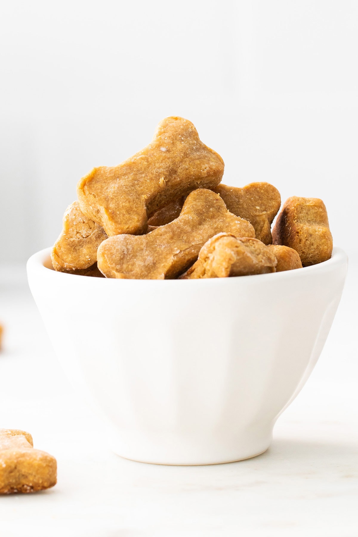 Bowl of bone-shaped homemade dog treats.