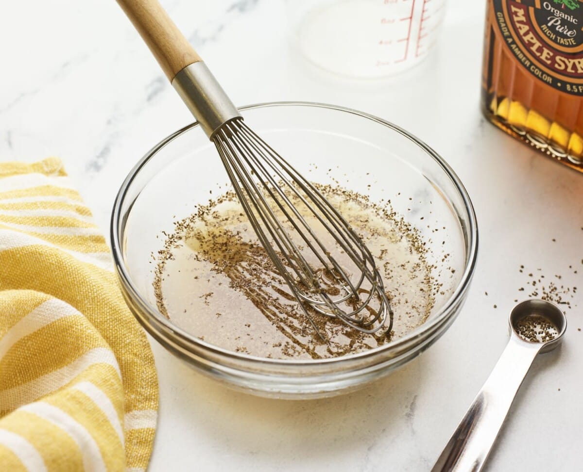 Whisk in a bowl of a vinegar dressing for coleslaw.