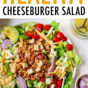 Cheeseburger salad with avocado, red onion, cheddar cheese, tomatoes, ground turkey and pickles.