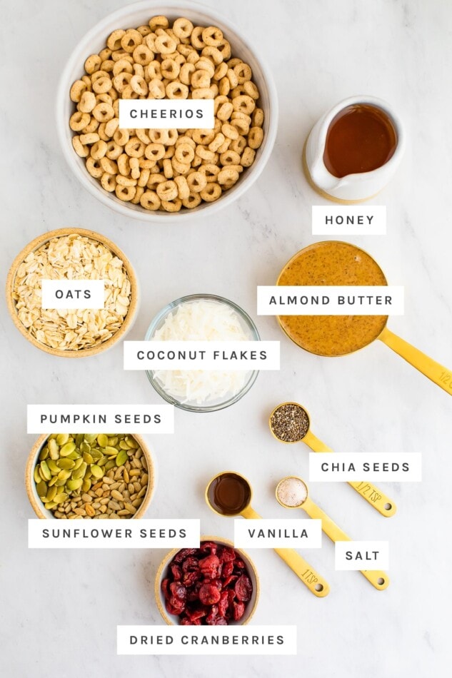 Superfood Cereal Squares -- Like trail mix in bar form, these cereal squares are packed with nutrient dense superfood seeds, whole grain cereal and dried fruit. They’re held together with a blend of almond butter and honey so they’re nutty, sweet and perfectly chewy with a little crunch from the cereal. Ingredients for cereal bars laid out on a marble surface with labels.