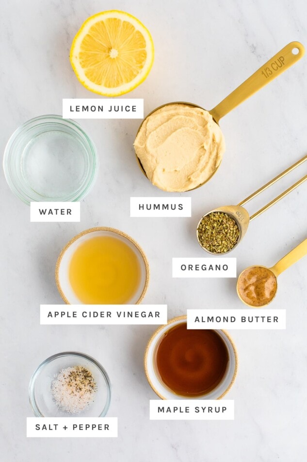 Kaleidoscope Salad with a Curried Hummus Dressing Ingredients measured out for hummus dressing: lemon, hummus, water, oregano, vinegar, almond butter, maple syrup, salt and pepper.