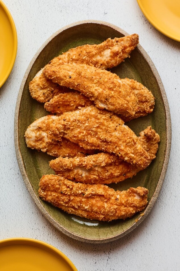 Overhead photo of a serving platter with baked chicken tenders.