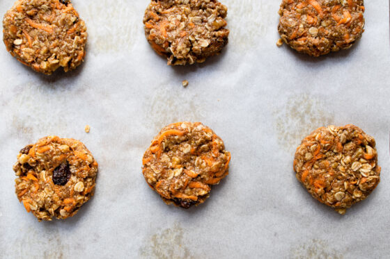 Multiple carrot cake cookies on a baking sheet before being baked.