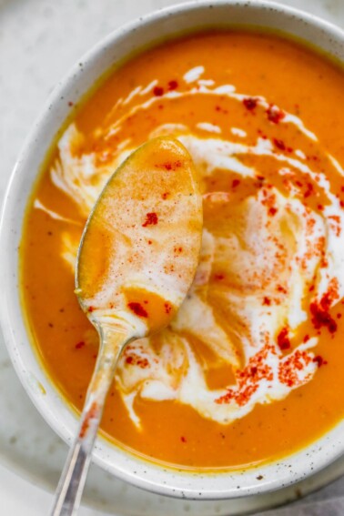 An overhead photo of a spoon ladling out some soup from a bowl.