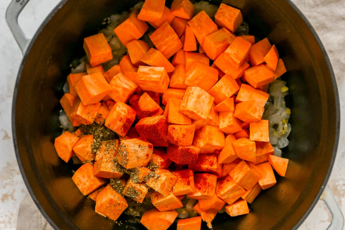 Overhead photo of ingredients for sweet potato soup in a large pot.