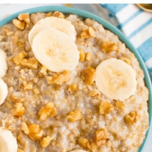 Bowl of steel cut oats topped with walnuts and banana slices.
