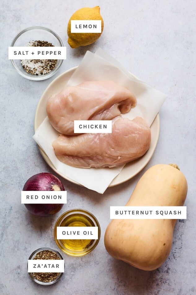 Get inspired by Middle Eastern flavors with this one pan za'atar chicken bake. It's easy to whip up and tastes incredible, especially with a drizzle of tahini dressing. Paleo, gluten-free and whole30 approved. Ingredients measured out to make za'atar chicken bake: salt, pepper, lemon, chicken, red onion, butternut squash, olive oil and za'atar.