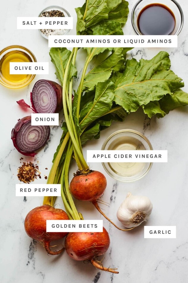 Ingredients measured out to make sautéed beet greens and roasted beets: salt, pepper, coconut aminos, olive oil, golden beets, onion, vinegar, red pepper and garlic.