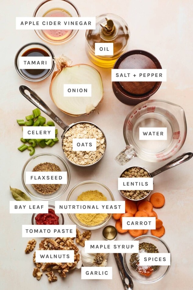 Ingredients measured out to make a lentil loaf: vinegar, oil, salt, pepper, tamari, onion, water, celery, oats, flaxseed, lentils, bay leaf, nutritional yeast, carrot, tomato paste, maple syrup, spices, walnuts and garlic.