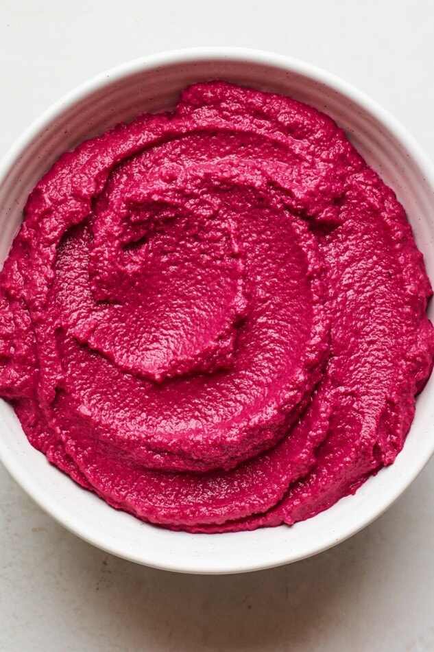 An overhead photo of a bowl of beet hummus.