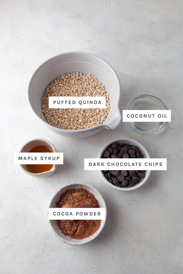 Quinoa No Bake Cookies // Classic no-bake cookies get a healthy upgrade with the addition of quinoa flakes. They’re the perfect sweet treat for the holiday season. Gluten-free & vegan. Ingredients measured out to make chocolate quinoa crunch bites: puffed quinoa, coconut oil, maple syrup, dark chocolate chips and cocoa powder.