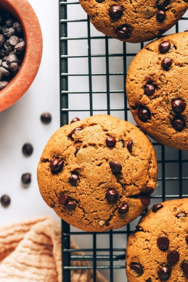 An overhead photo looking down on healthy chocolate chip cookies on a wire cooling rack.
