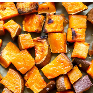 Roasted sweet potato croutons on a sheet pan.