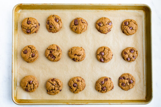 Baked cookies on a baking sheet lined with parchment paper.