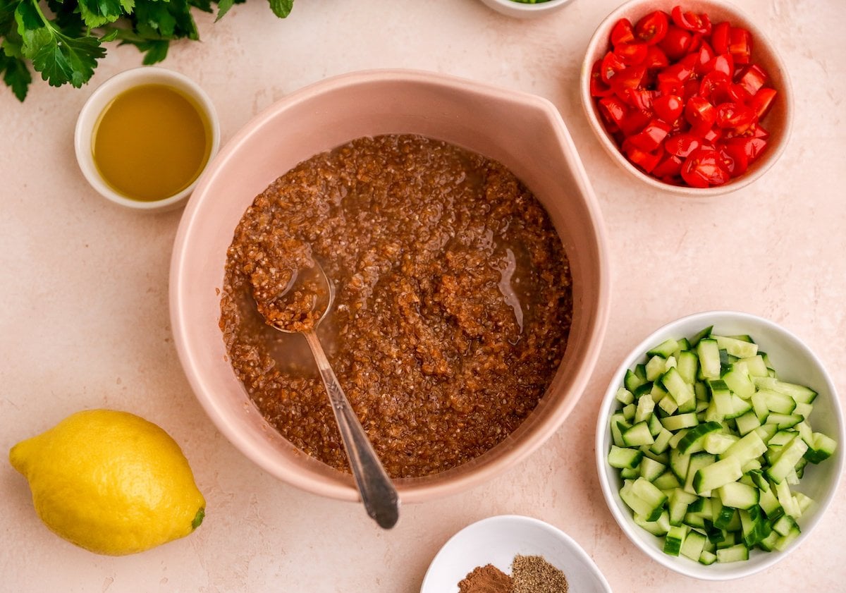 Bulgur wheat soaking up water in a mixing bowl.