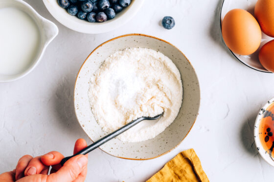 A small mixing bowl containing coconut flour, baking powder and salt.
