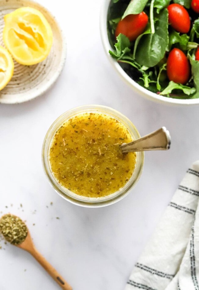 An overhead photo of a jar with lemon vinaigrette.