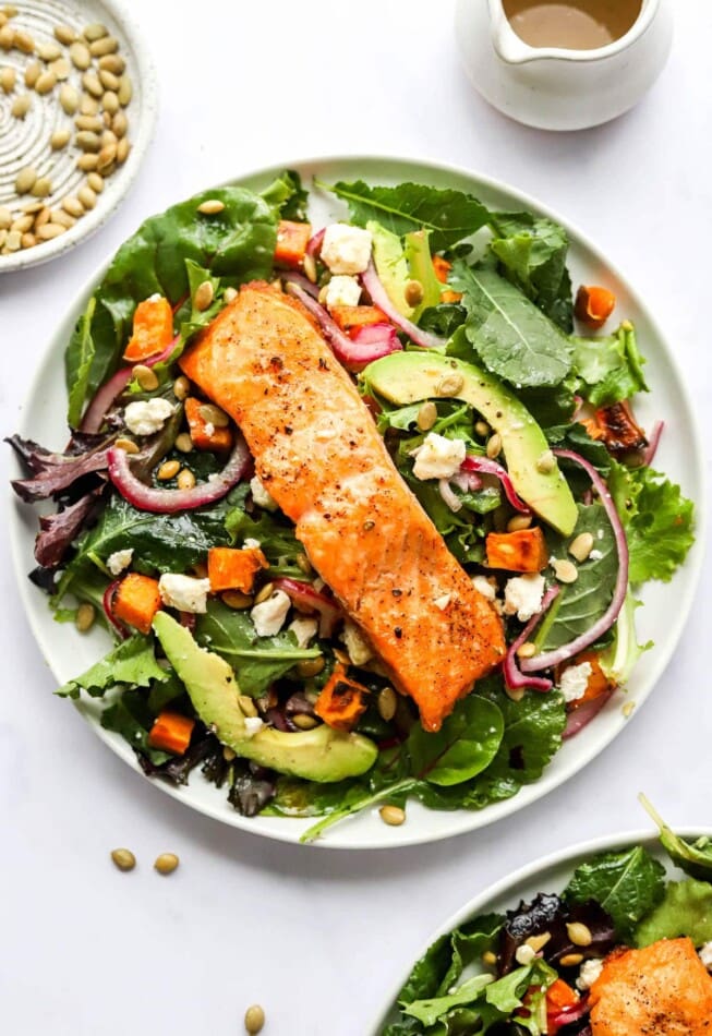 PIN THIS --> Seared Salmon Salad A plate of superfood salad topped with a filet of salmon topped with quick pickled onions, sweet potato croutons and a lemon vinaigrette.