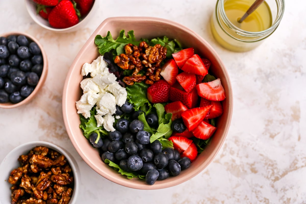 Ingredients for summer berry salad in a mixing bowl.