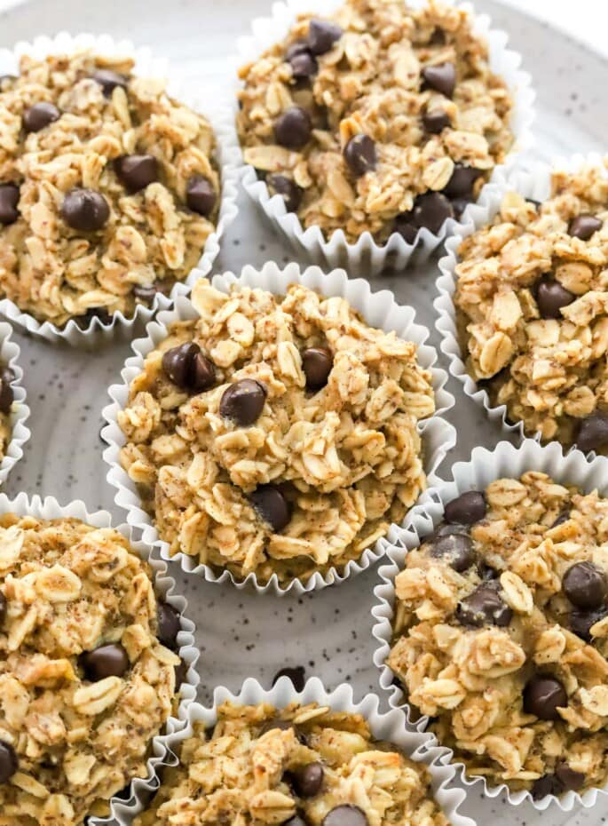Close up of oatmeal cups wrapped in paper liners on a plate.