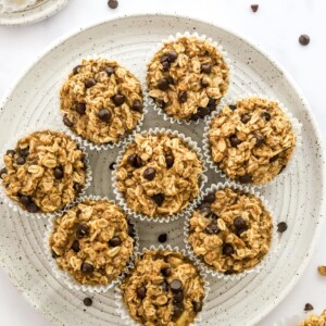 Oatmeal cups wrapped in paper liners on a plate.