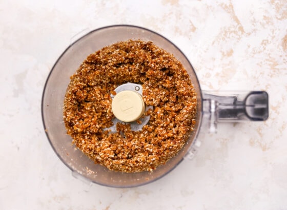 Crust for cheesecake bars mixed together in a food processor.