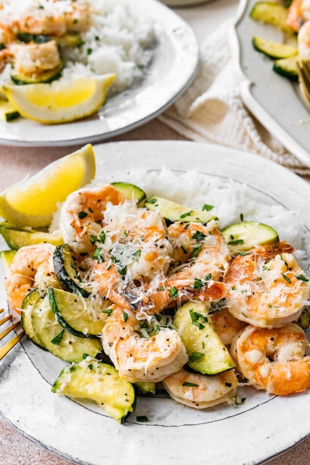 A plate with rice and a serving of shrimp scampi.