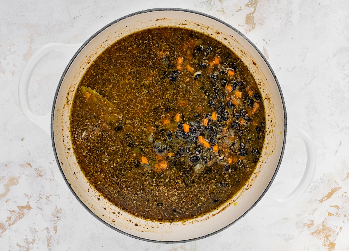 Ingredients for black bean soup added to pot.
