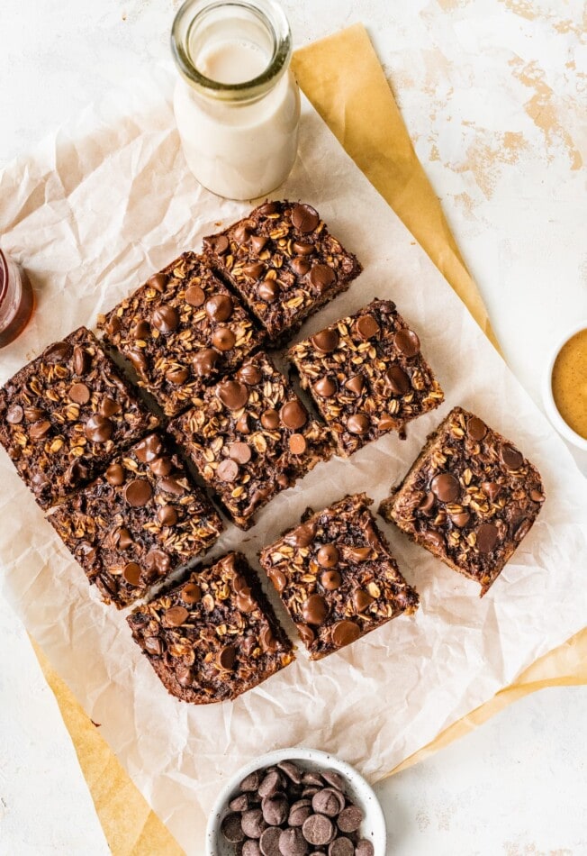 Baked oatmeal cut into 9 portions on a sheet of parchment paper.