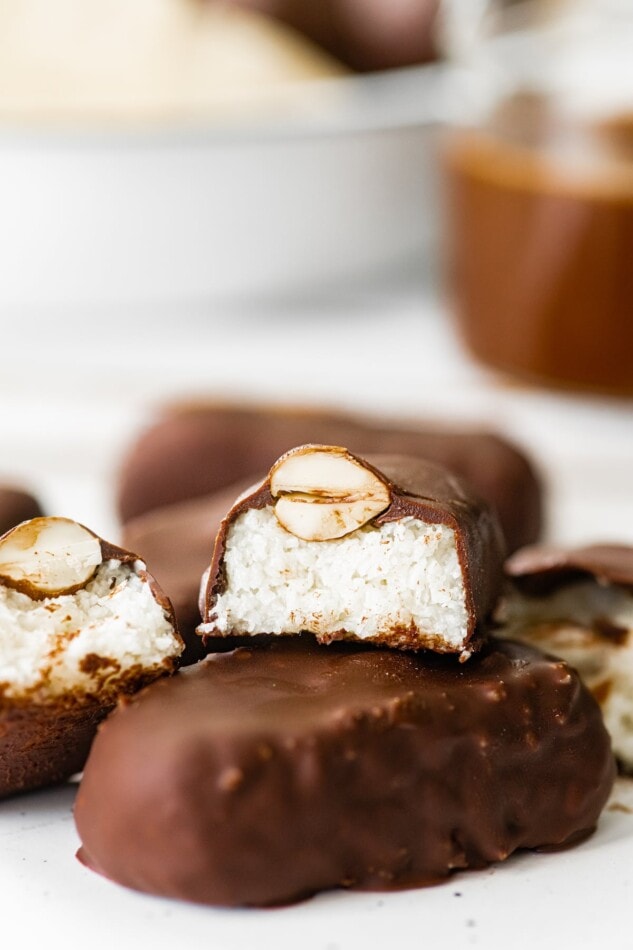 A halved almond joy bar stacked on top of a full bar.
