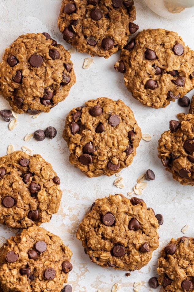 Cookies scattered around a sheet of parchment paper.