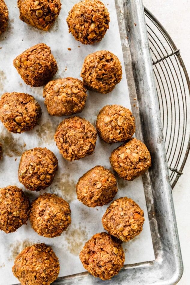 Lentil meatballs on a parchment lined baking sheet.