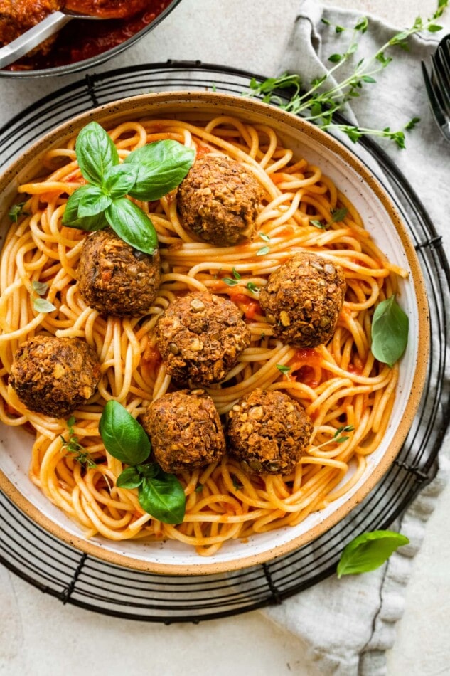 Lentil meatballs atop spaghetti noodles with tomato sauce.