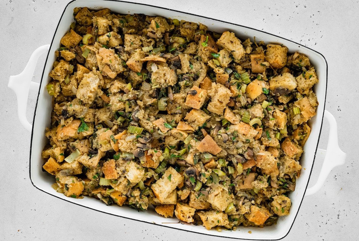 Sourdough stuffing mixture spread in a baking dish.