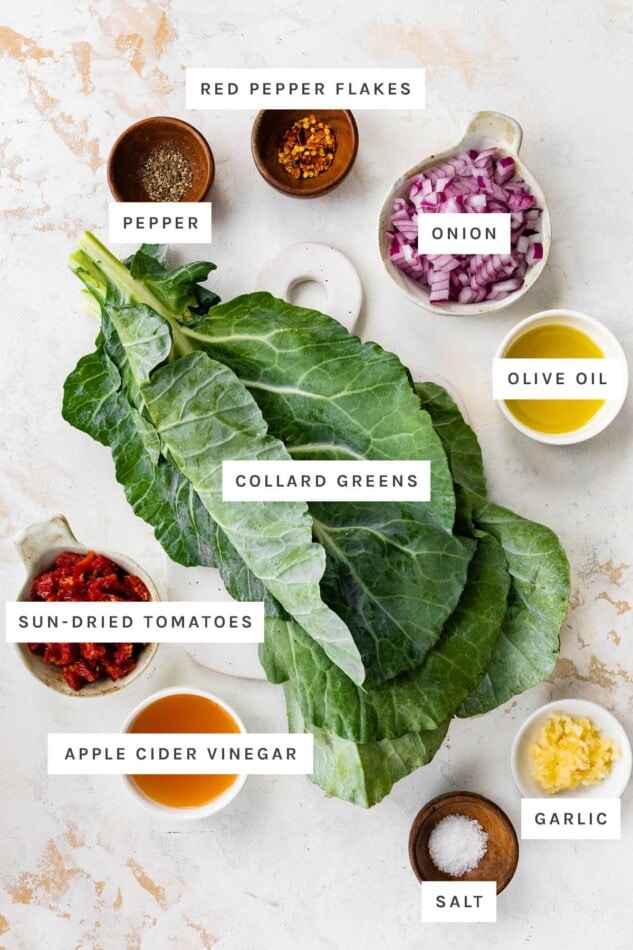 Pin this image to save this healthy collard green salad for later! Ingredients measured out to make Raw Collard Greens Salad: red pepper flakes, pepper, onion, olive oil, collard greens, sun-dried tomatoes, vinegar, salt and garlic.