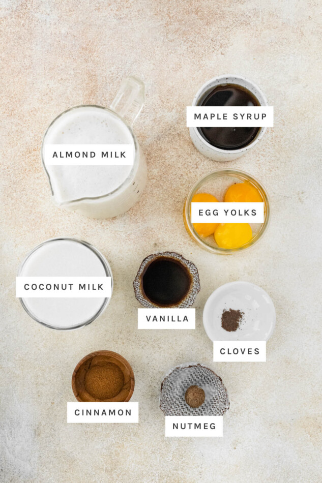 A healthier take on festive holiday eggnog, this clean eating eggnog uses almond and coconut milk, egg whites and pure maple syrup. It's lighter in calories and dairy-free but still just as delicious as real deal nog. Ingredients measured out to make Dairy-Free Eggnog: almond milk, maple syrup, egg yolks, coconut milk, vanilla, cloves, cinnamon and nutmeg.