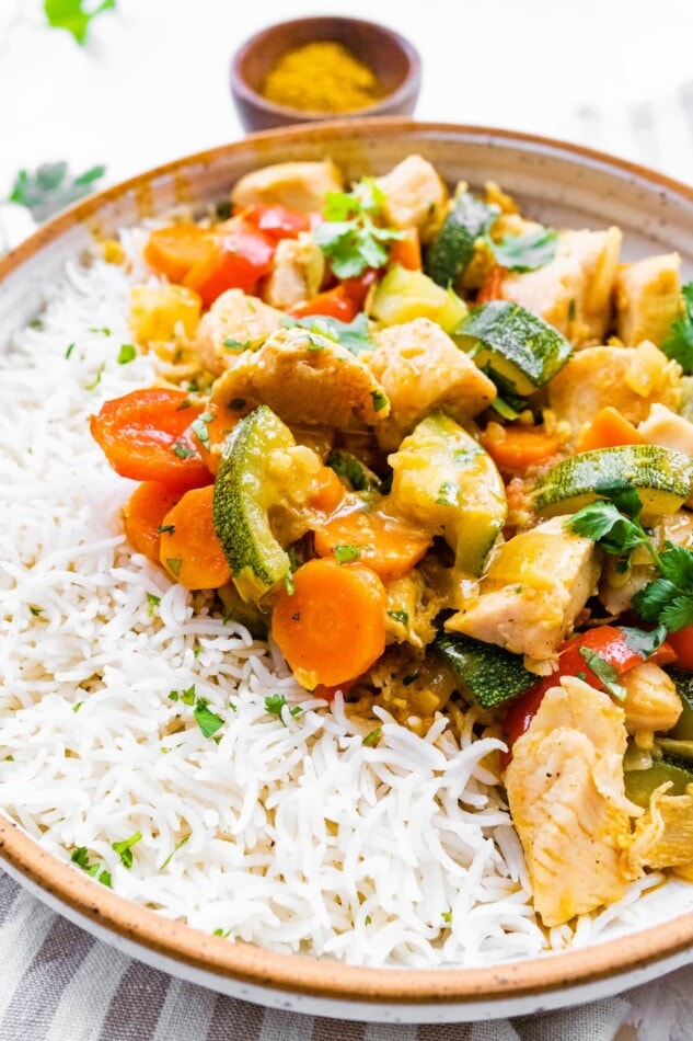 Chicken curry with vegetables served with rice.