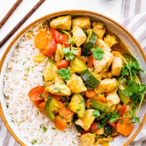 Chicken curry with vegetables served with rice.