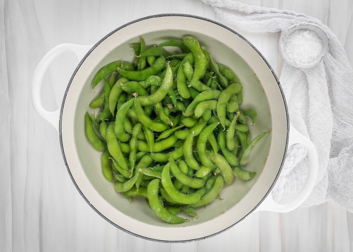 Edamame cooking in boiling water.