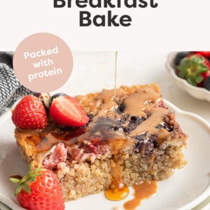 Plated quinoa breakfast baked served with peanut butter, maple syrup and berries.