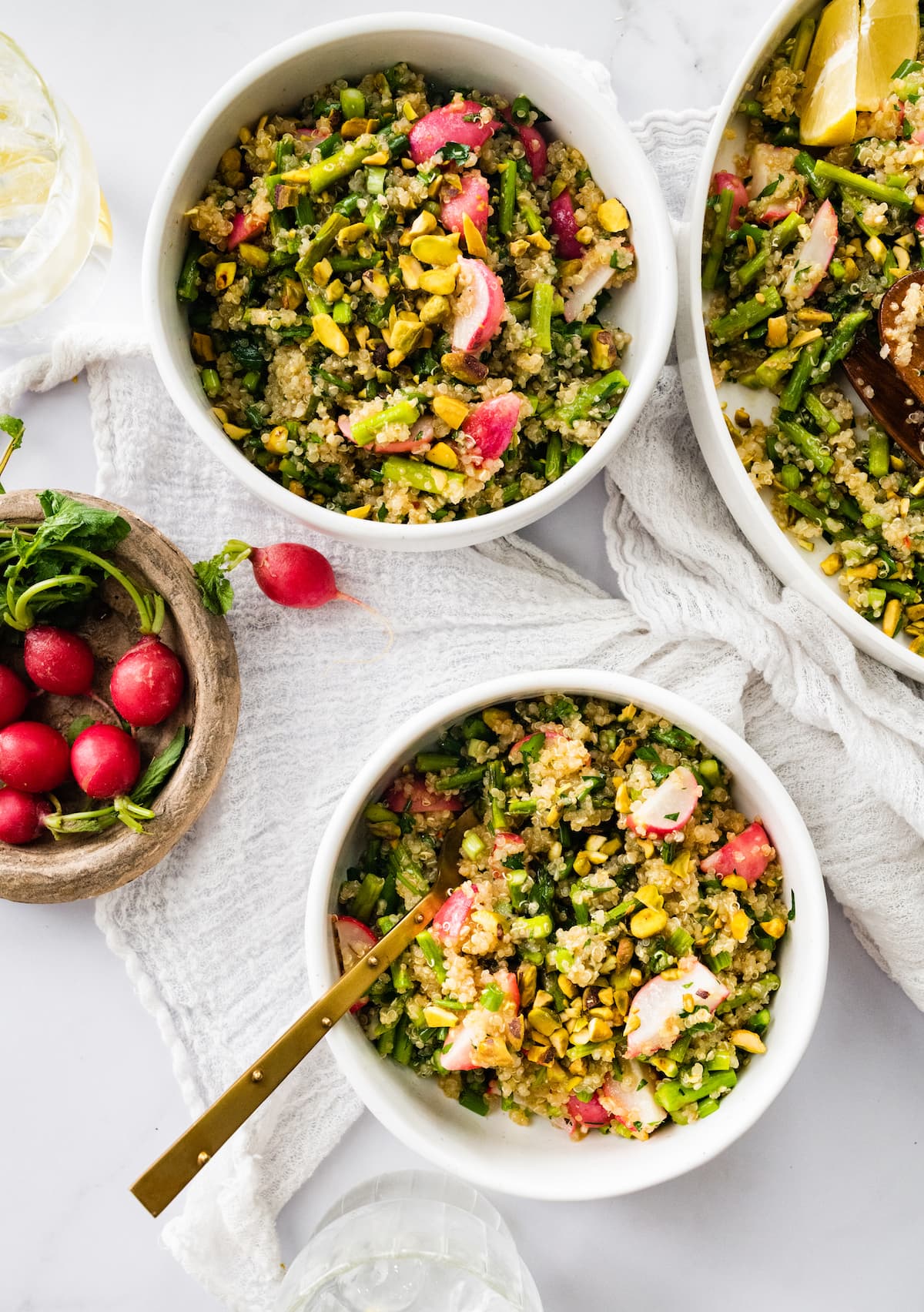 Spring quinoa salad with roasted asparagus and radishes Two bowls of spring quinoa salad.