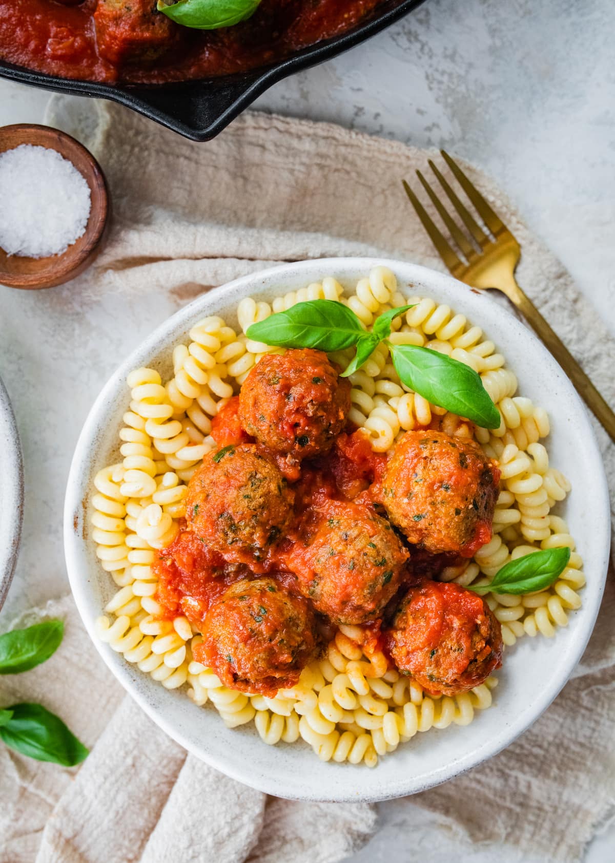 These simple clean eating Popeye turkey meatballs are moist and flavorful, loaded with veggies and require no binders! Great for meal prep because you can add them to pasta, sandwiches, salads and more throughout the week! Gluten-free, dairy-free, paleo. Spinach turkey meatballs served over pasta.
