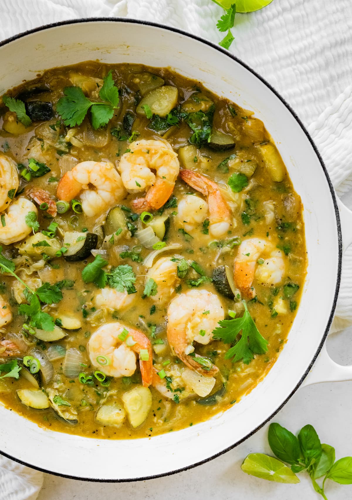Thai Green Shrimp Curry over Zucchini Noodles #lowcarb #healthy #cleaneating A pot full of thai green curry with shrimp.