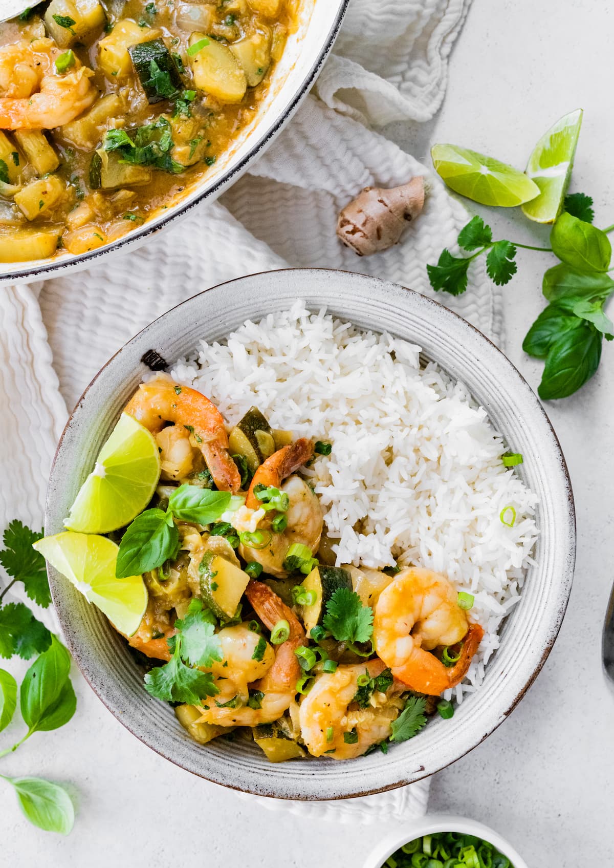 Thai Green Curry with Shrimp over brown rice -- quick, easy and perfect for weeknights! A bowl of thai green curry with shrimp served with rice.