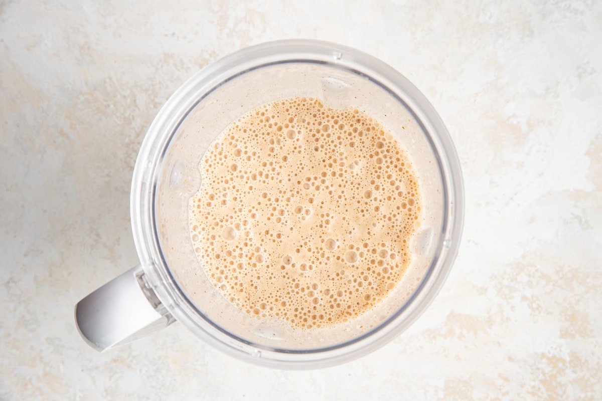 Banana almond butter smoothie blended together in blender.