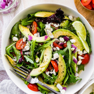 Deconstructed guacamole salad with a fork.