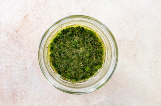 Combined cilantro lime dressing in a mason jar for deconstructed guacamole salad.